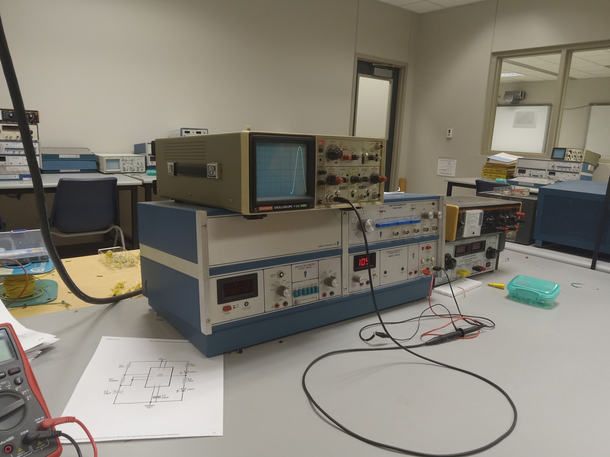 Electronics lab with oscilloscopes and circuit testing equipment