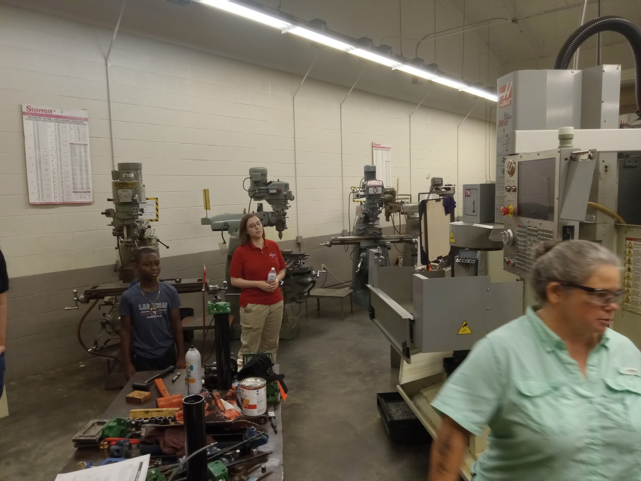 Instructor leading students through the precision machining shop