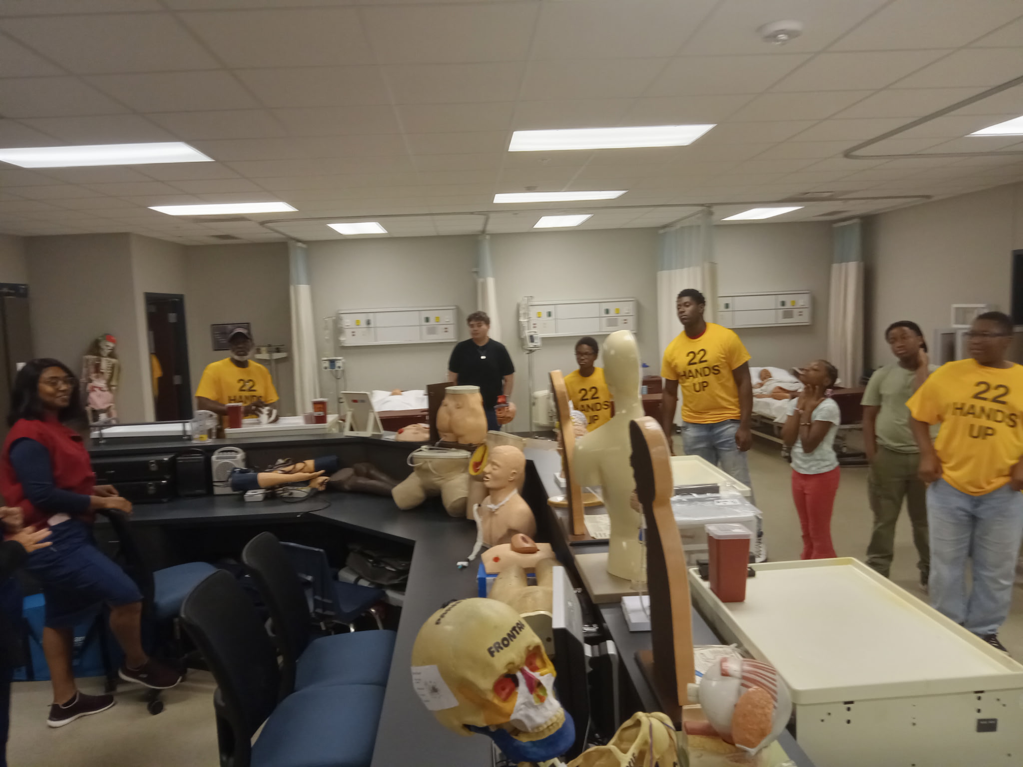 Students touring the nursing simulation lab with medical mannequins