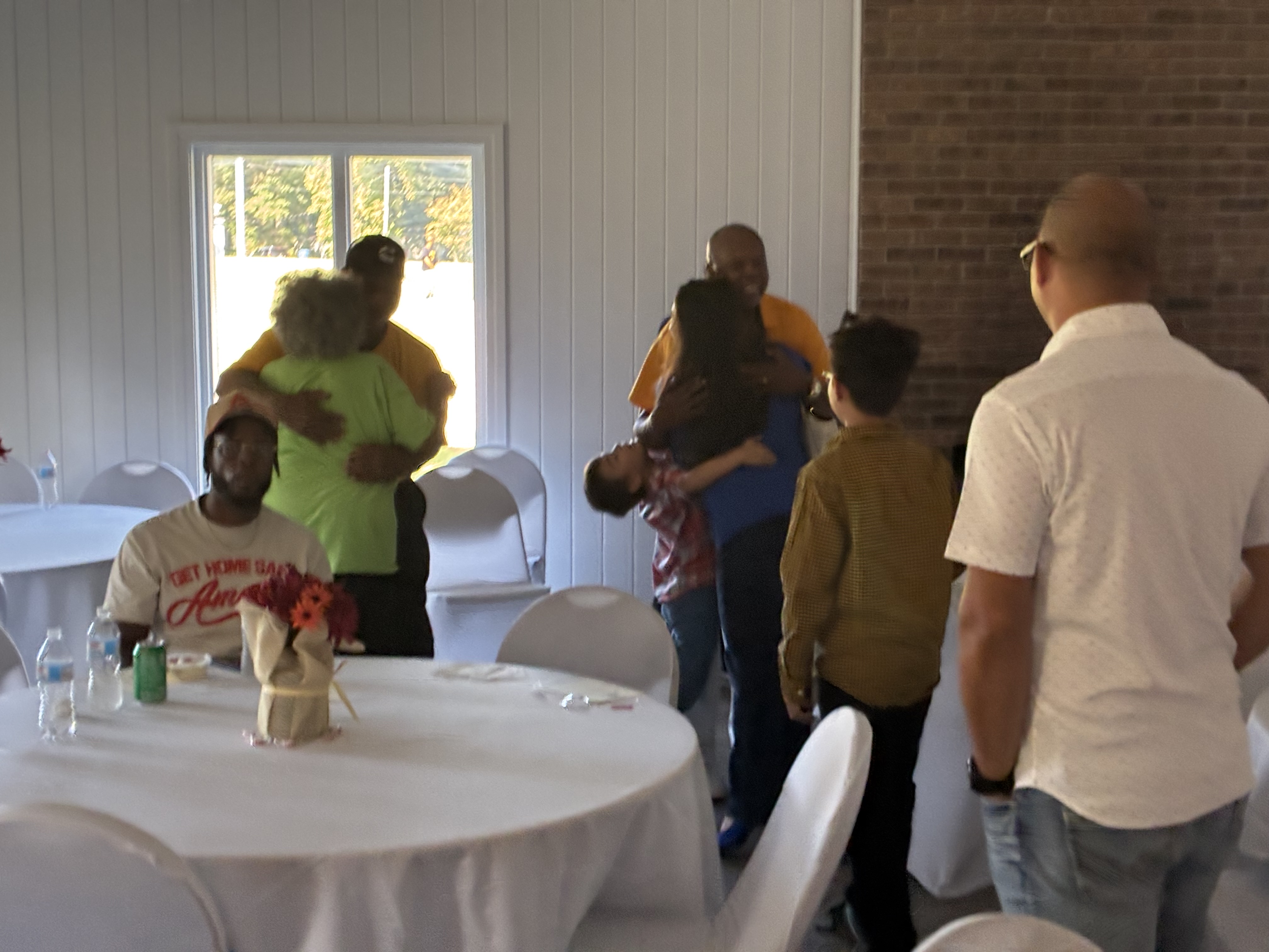 Community members embracing and celebrating at Food Fest 2025